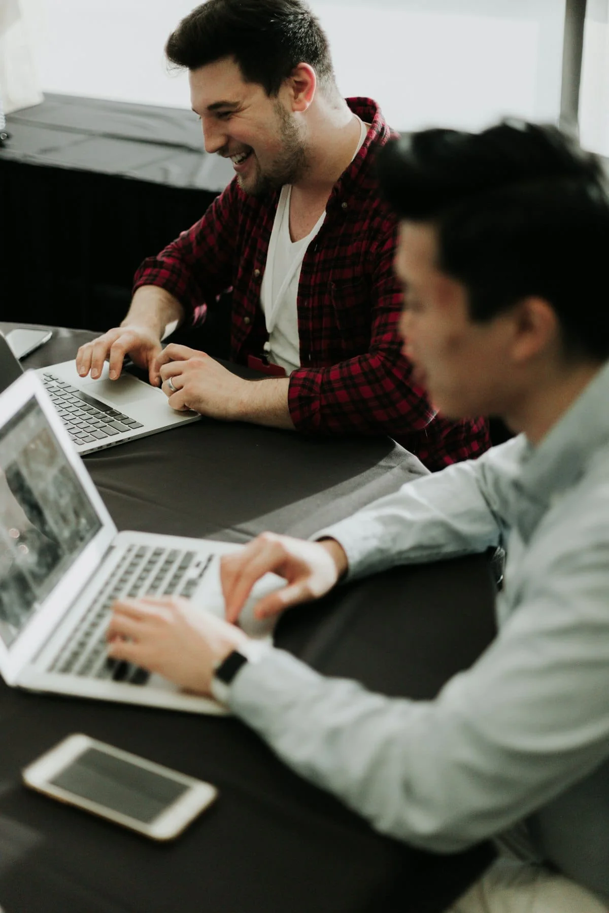 Stressed business owner sitting at a laptop, reviewing an incomplete website project after their web designer stopped responding
